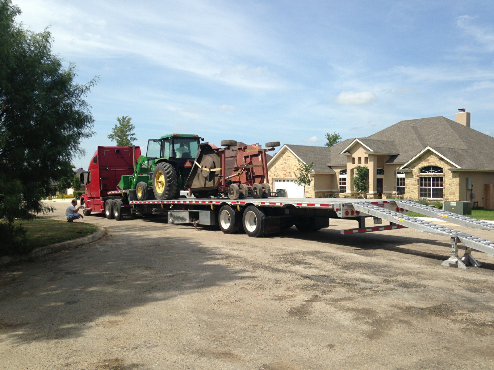 Agricultural tractor and mower attachment ready for hauling